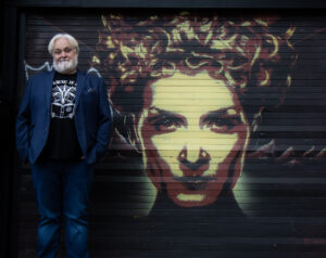 Caimh stood in front of graffitti of Medusa